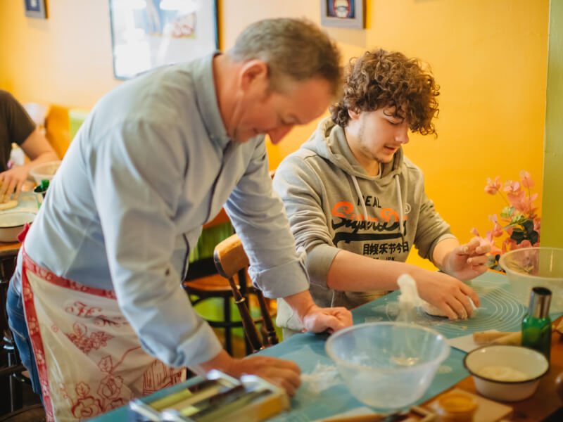 Father and son in a pasta making class